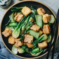 A super quick and easy stir fried bok choy with tofu puffs that only uses five ingredients and takes 15 minutes to prep and cook. The crisp bok choy is lightly caramelized and combined with tender tofu in a savory and slightly sweet sauce. It is surprisingly satisfying to eat as a side dish, and sometimes I serve it as a light main dish for lunch over steamed rice. {Vegan, Gluten-Free Adaptable}