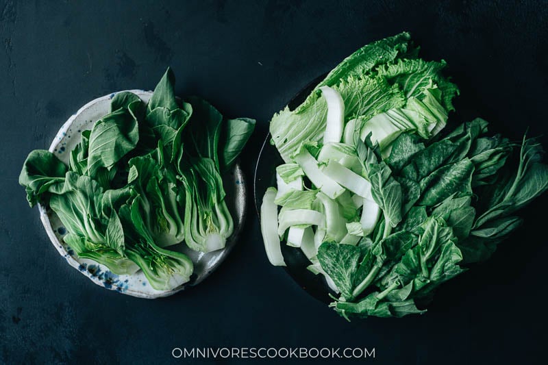 Plated baby bok choy, napa cabbage and pea shoots