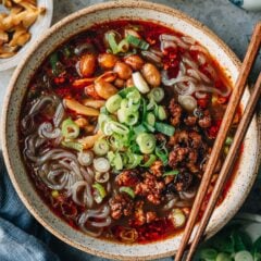Sharing a signature Sichuan dish Suan La Fen - a bowl of tender springy potato noodles smothered in a rich savory hot and sour soup topped with crispy pork and peanuts. It’s quite easy to put together and addictive to eat! {Vegetarian / Vegan Adaptable, Gluten-Free Adaptable}