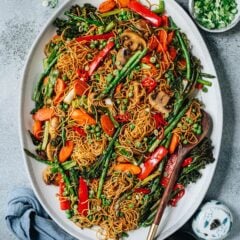 Introducing a super easy sheet pan chow mein recipe that features beautifully charred noodles loaded with colorful vegetables. It takes no time to put together, requires very little active cooking time, and the clean up is a breeze! {Vegetarian}