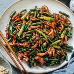 Garlic scape stir fry with pork is a Chinese homestyle dish that helps you incorporate garlic scapes into your weekday dinner. The crisp garlic scapes are cooked with tender pork in a brown sauce that&rsquo;s just enough to coat the ingredients. It&rsquo;s fragrant, rich, and comforting, making it a hearty main dish over steamed rice. {Gluten-Free Adaptable}