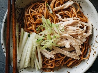 Chinese chicken noodle salad garnished with cucumber