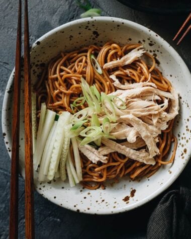Chinese chicken noodle salad garnished with cucumber