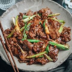 This easy Mongolian beef recipe features beautifully caramelized beef with a juicy, tender texture. And a gingery, garlicky, sweet and savory sauce makes this dish irresistible! You won&rsquo;t believe how easy it is to make this restaurant-style stir fry in your own kitchen without a wok! {Gluten-Free adaptable}