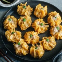 Cantonese shumai are fresh, juicy pork and shrimp filled dumplings with thin, bright yellow wrappers. Learn how to make shumai like the ones at a dim sum shop.
