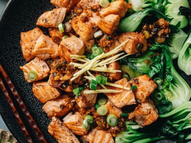 Pan fried salmon served with baby bok choy close up
