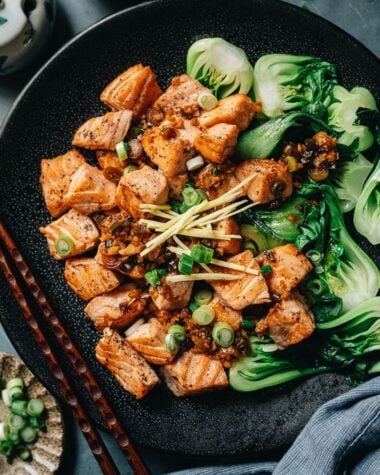 Pan fried salmon served with baby bok choy close up