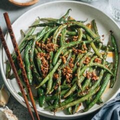 This air fryer garlic green beans recipe features blistered green beans cooked with a bold and savory garlic sauce. It uses less than 5 ingredients and takes less than 10 minutes to put together, so it&rsquo;s a perfect quick side dish for your dinner. {Vegan, Gluten-Free Adaptable}