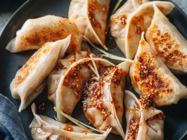 Chinese chicken dumplings served with dipping sauce and chili oil