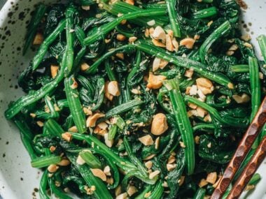 Chinese spinach salad with peanuts close up