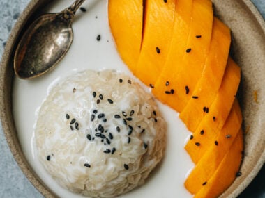 Traditional Thai mango sticky rice with black sesame seeds topping