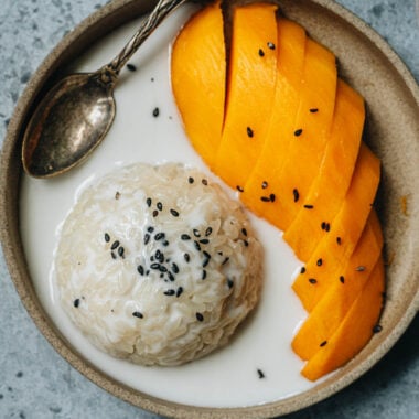 Traditional Thai mango sticky rice with black sesame seeds topping