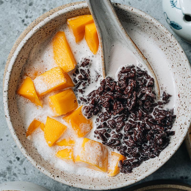Black rice pudding is a healthy dessert made from ingredients you wouldn&rsquo;t expect! Gooey rice soaked in sweetened coconut milk and paired with fresh summer fruit is a tantalizing treat that will refresh you on the hottest days! {Gluten-Free, Vegan}