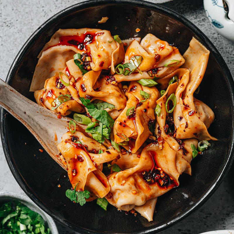 An authentic spicy wonton in chili oil recipe that yields tender wontons smothered in the most scrumptious sauce that is spicy, savory and sweet, just like the street food you’d get in Sichuan