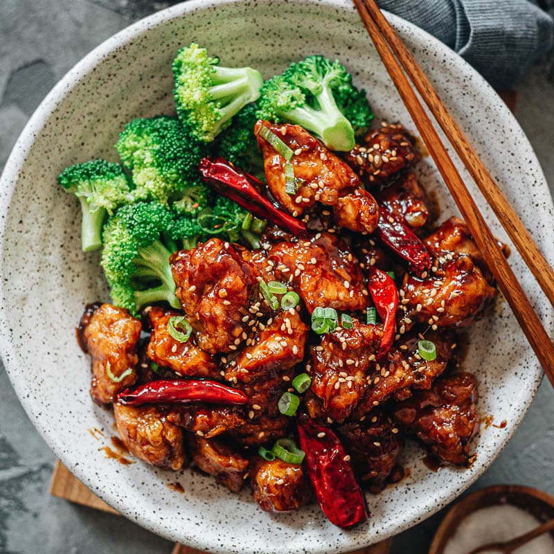 An easy General Tso's chicken recipe that yields crispy chicken without deep-frying, served with a sticky, tangy, and sweet sauce. It also uses much less sugar while maintaining a great bold taste. Once you&rsquo;ve tried it, you&rsquo;ll skip takeout next time because it&rsquo;s so easy to make in your own kitchen and the result is just as good. {Gluten-Free Adaptable}