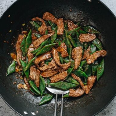 Steak and green beans stir fry in a wok
