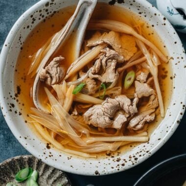 Sliced pork soup with lily flower in a bowl