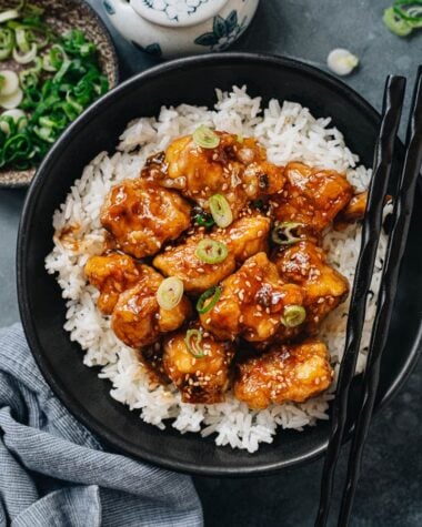 Crispy sesame chicken over steamed rice