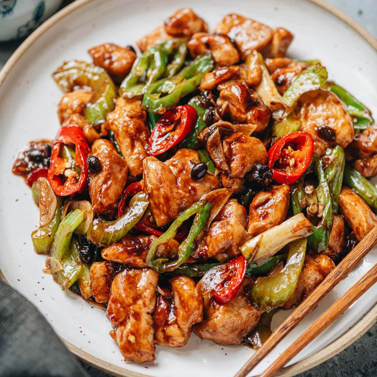 An authentic tasting Hunan chicken that features tender chicken pieces and hot peppers cooked in a rich savory sauce made with fermented black beans and aromatics. If you enjoy a takeout style Hunan chicken, as well as spicy food with a punch, you can&rsquo;t miss this one. {Gluten-Free Adaptable}