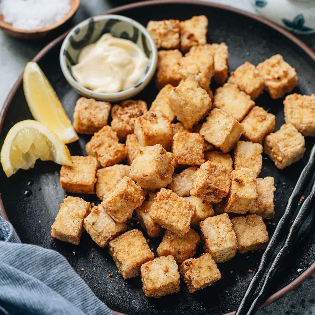 These air fryer tofu bites are extra crunchy and crispy, tossed with a delicious pepper salt spice mix. It&rsquo;s a perfect snack or appetizer served by itself, or a great topping for your rice and salad bowls. {Vegetarian, Gluten-Free Adaptable}
