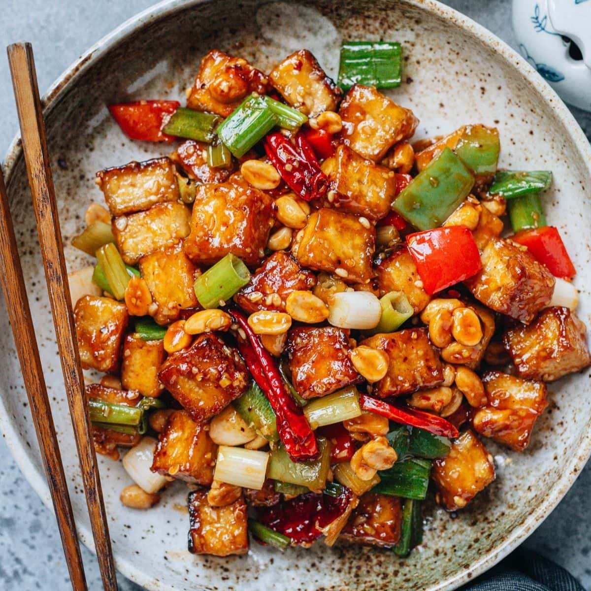 Kung pao tofu is a bold tasting stir-fry that captures everything people love about Sichuan cuisine. Golden crispy tofu cubes soak up the rich sauce that&rsquo;s savory, sweet and tangy, spiced up with chili pepper and Sichuan peppercorn. Crunchy peanuts, sweet scallion, and crisp pepper add color and texture. It&rsquo;s a dish that&rsquo;s as comforting as it is exciting, perfect for anyone craving the punchy flavors of classic Chinese cooking