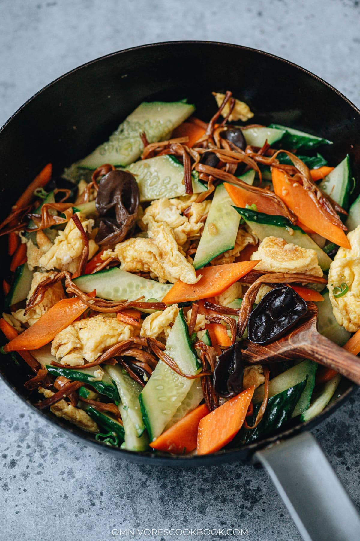 Cucumber and egg stir fry cooked in a wok