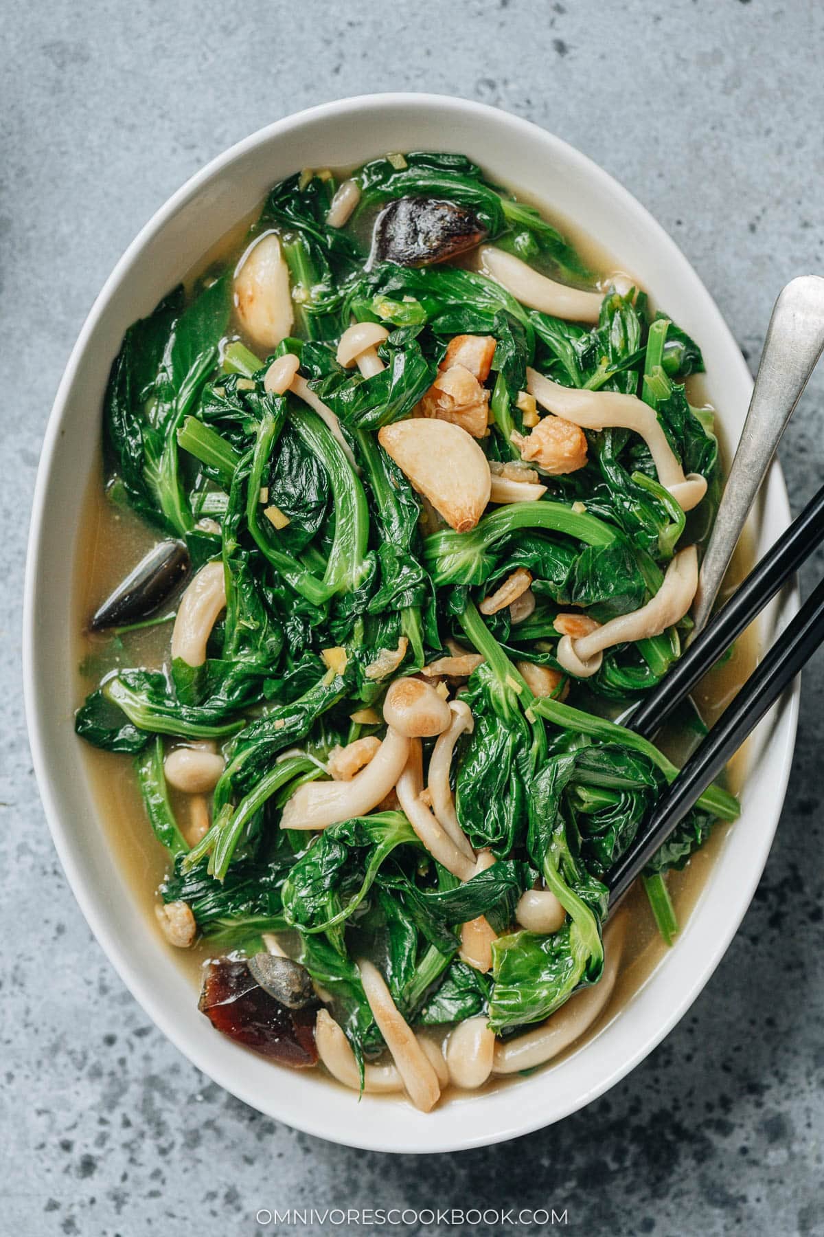 Chinese braised pea shoots with mushrooms close up
