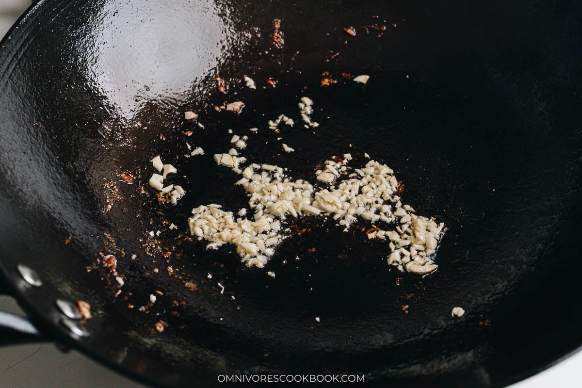 Minced garlic saut&eacute;ing in hot wok oil