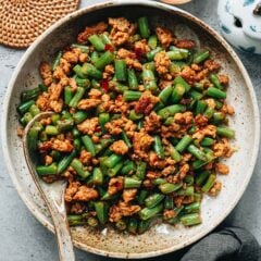 My stir fried green beans with ground pork is a dish that’s easy to put together and bold in flavor. It’s savory, slightly spicy, and packed with umami from doubanjiang, with tender-crisp green beans and juicy bits of pork in every bite. Served over a bowl of steamed rice, it makes a great one-bowl meal.