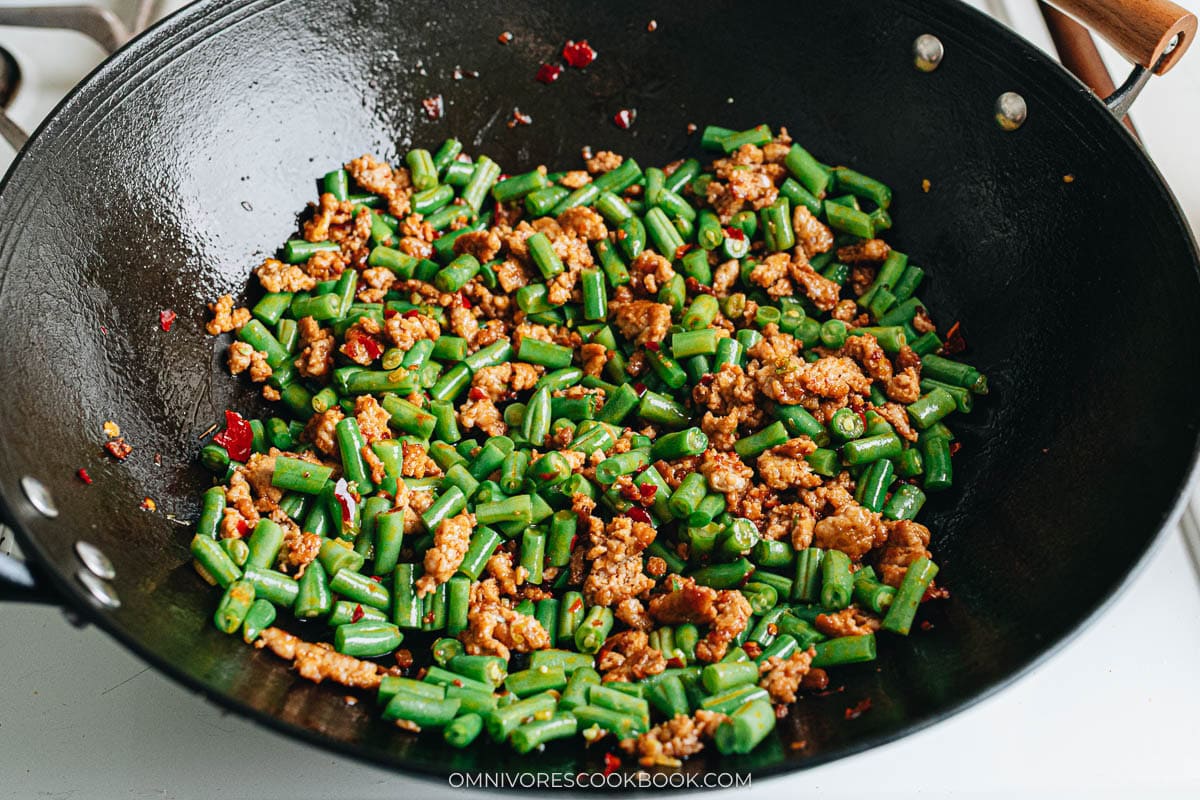 Green beans added to ground pork during stir frying