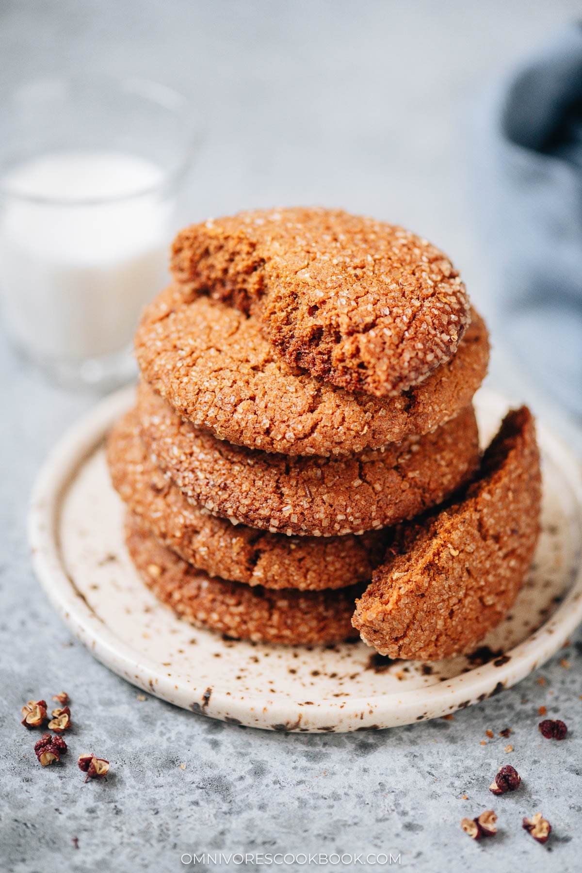 Stack of Sichuan peppercorn gingersnap cookies with crackly tops on a plate