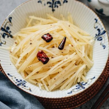 Close-up of Chinese shredded potato salad with dried chili on top