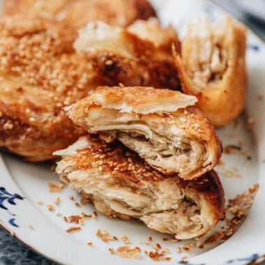 Cross section of guo kui showing flaky layers and savory pork filling