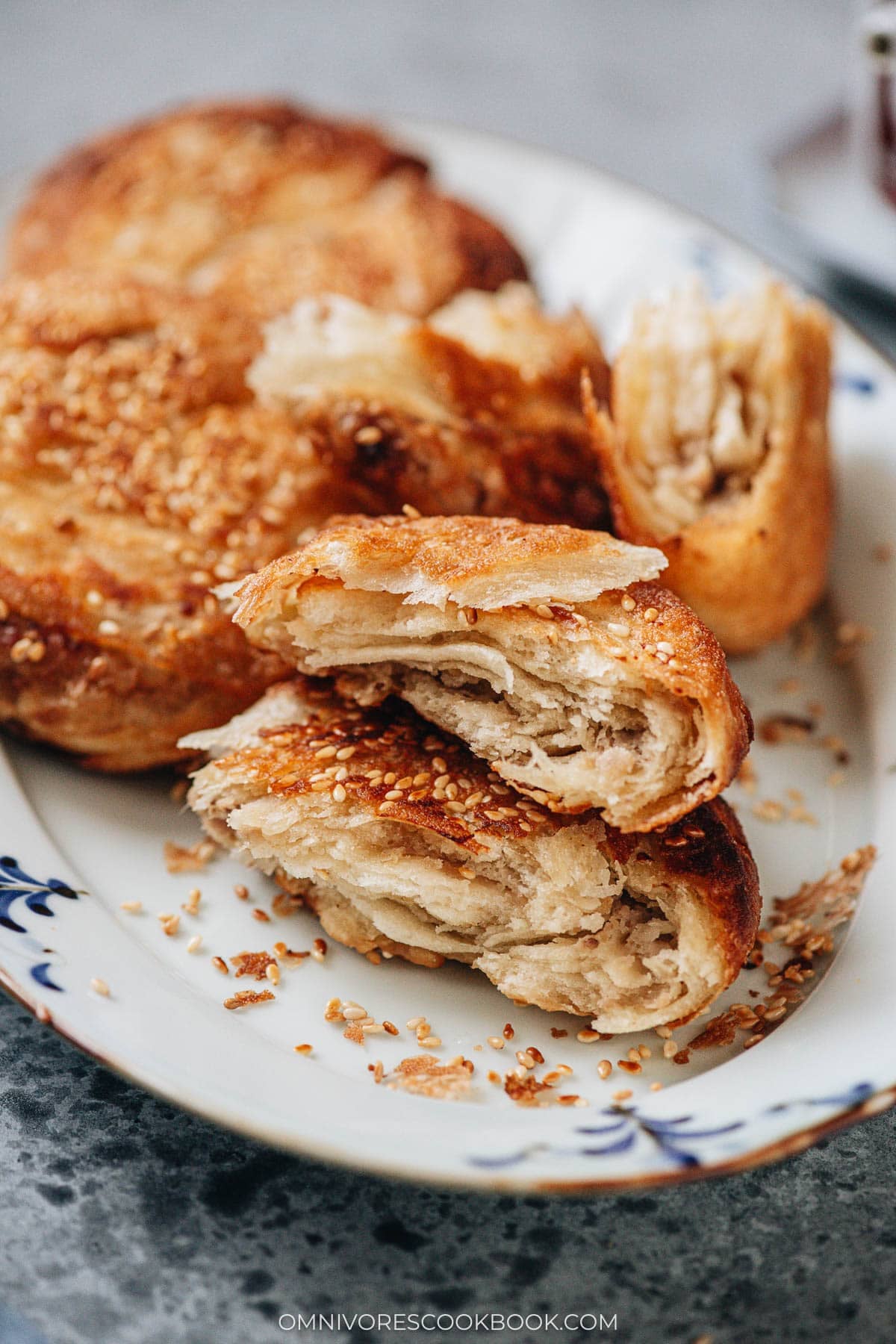 Cross section of guo kui showing flaky layers and savory pork filling