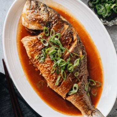 Chinese braised whole fish in soy sauce with scallions