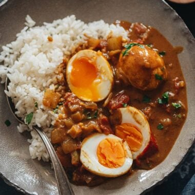 Egg curry served with steamed rice in a bowl