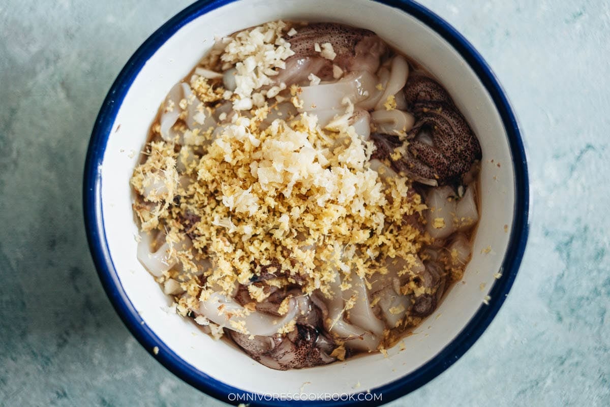 squid in a large bowl with the marinade ingredients