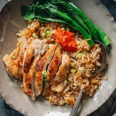 Carved chicken served on rice with Chinese broccoli