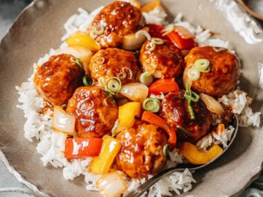 Meatballs with sweet and sour glaze over rice