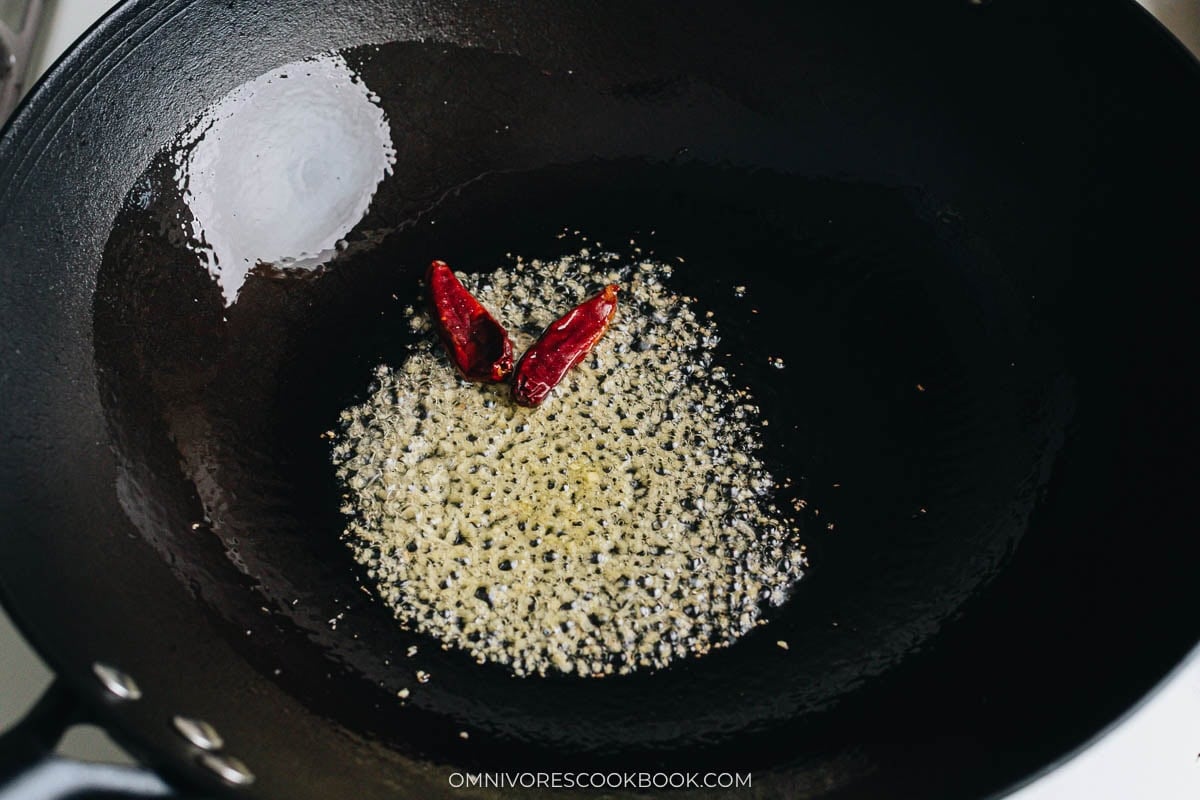 Ginger and dried chili blooming in hot oil