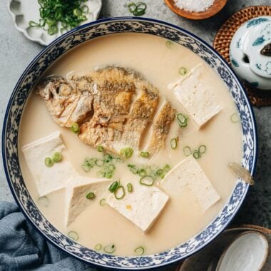 Chinese milky fish soup with whole fish and tofu in creamy white broth
