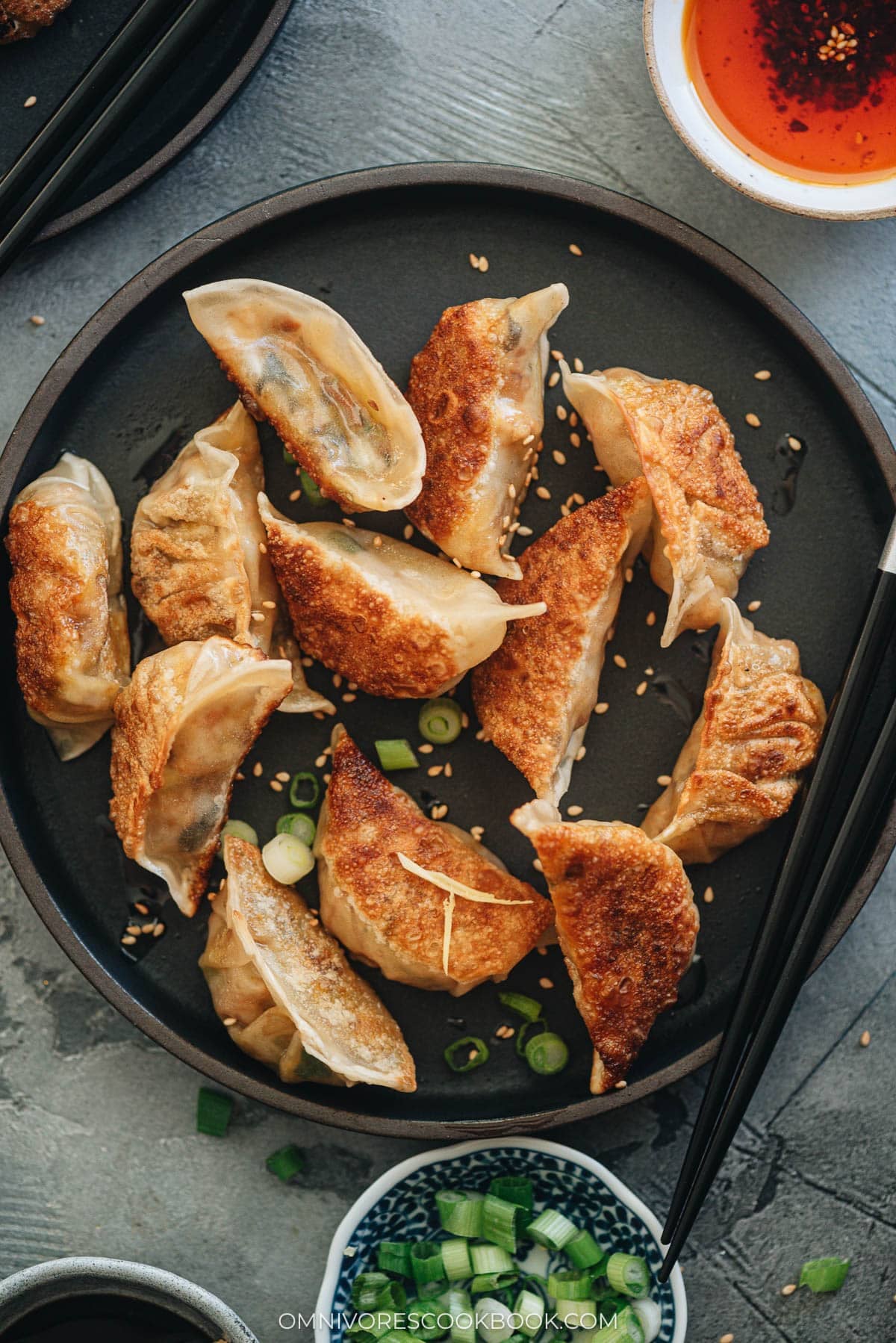 Homemade Vegan Dumplings - The dumpling filling has a well-balanced texture with veggies, tofu, and rice vermicelli. It’s seasoned with plenty of aromatics, soy sauce, and just a dash of curry powder to enhance its richness. #chinese #vegetarian Raw and cooked homemade vegan dumplings