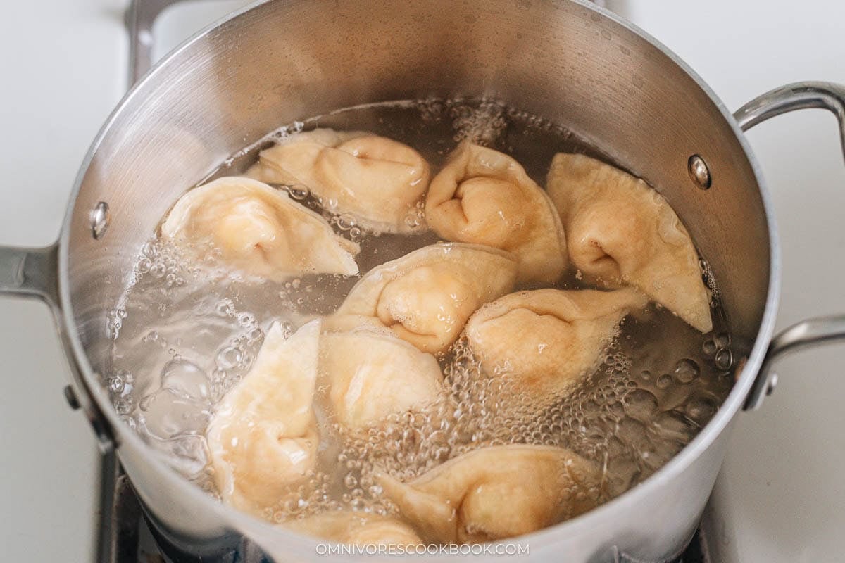 Wontons boiling in pot of water