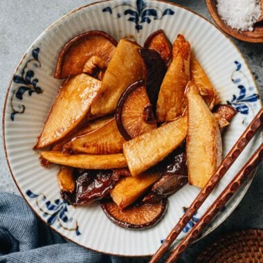Braised bamboo shoots and shiitake mushrooms served in a bowl with chopsticks