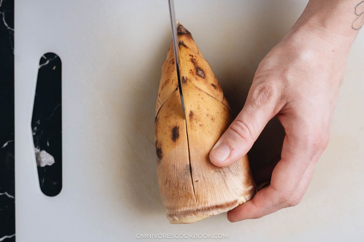 Slicing a slit over fresh bamboo shoot lengthwise