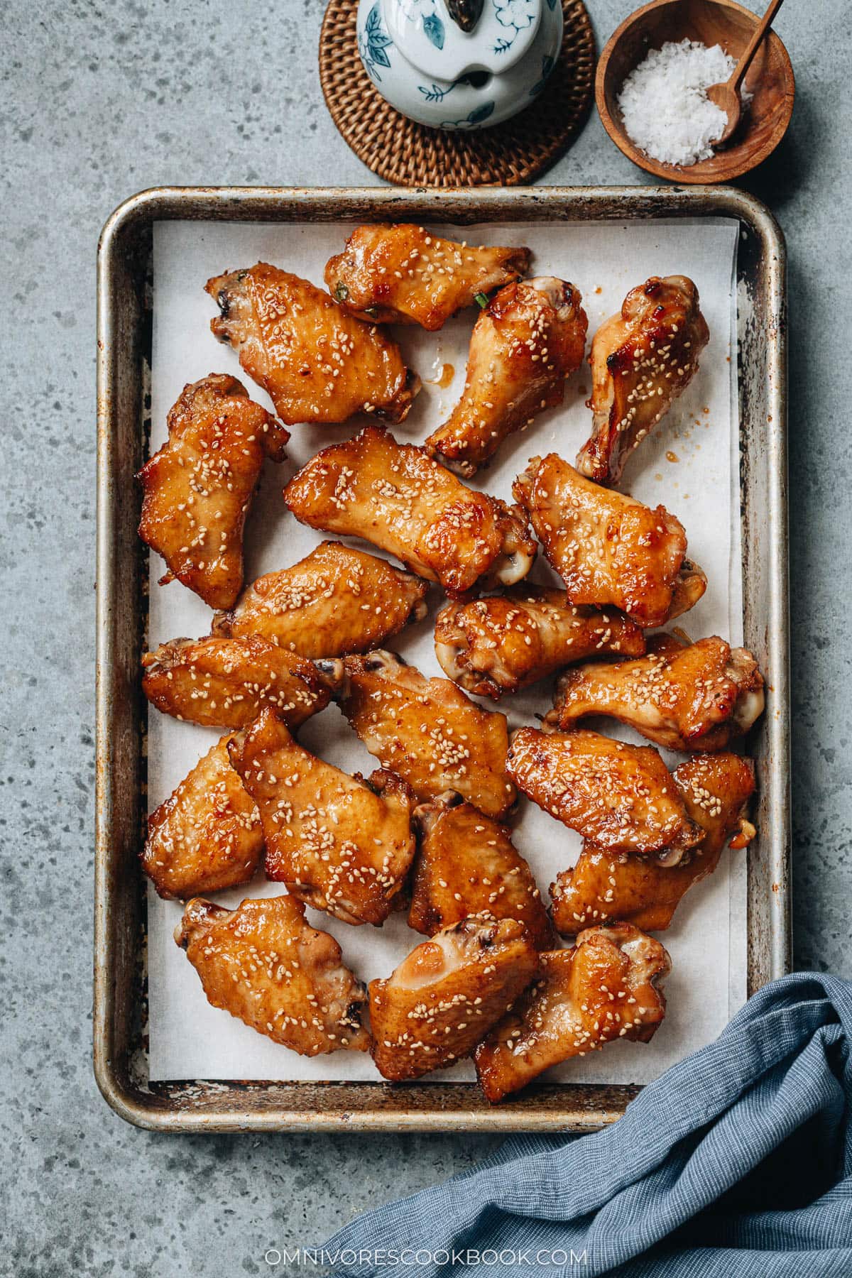 Baked Chimese honey soy chicken wings on parchment lined baking sheet