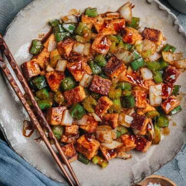 Close-up of crispy stir-fried tofu, green pepper, celery, and onion