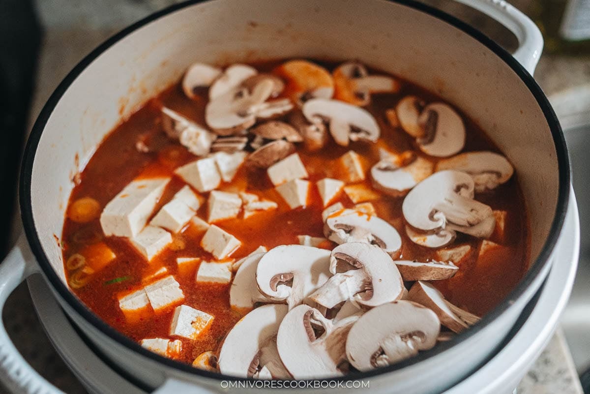 simmering the mushrooms and tofu 