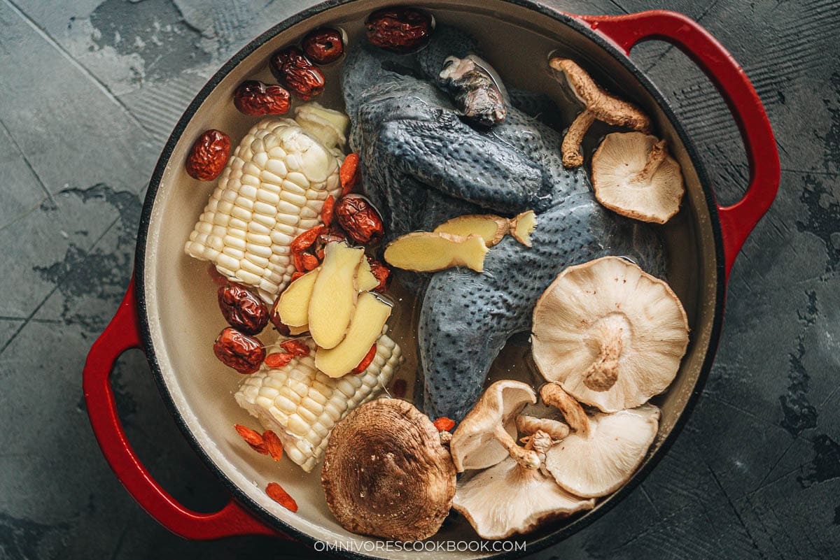 Chinese silkie chicken soup ingredients in a dutch oven