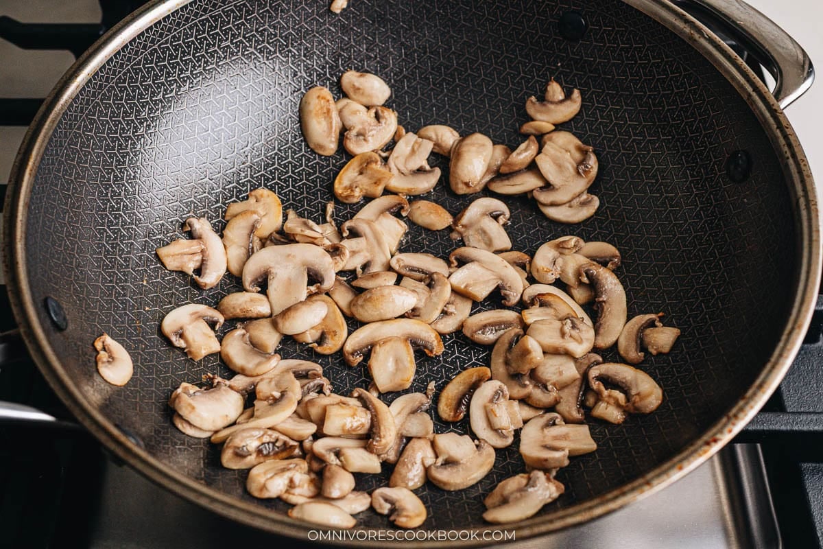Browning mushrooms in a wok